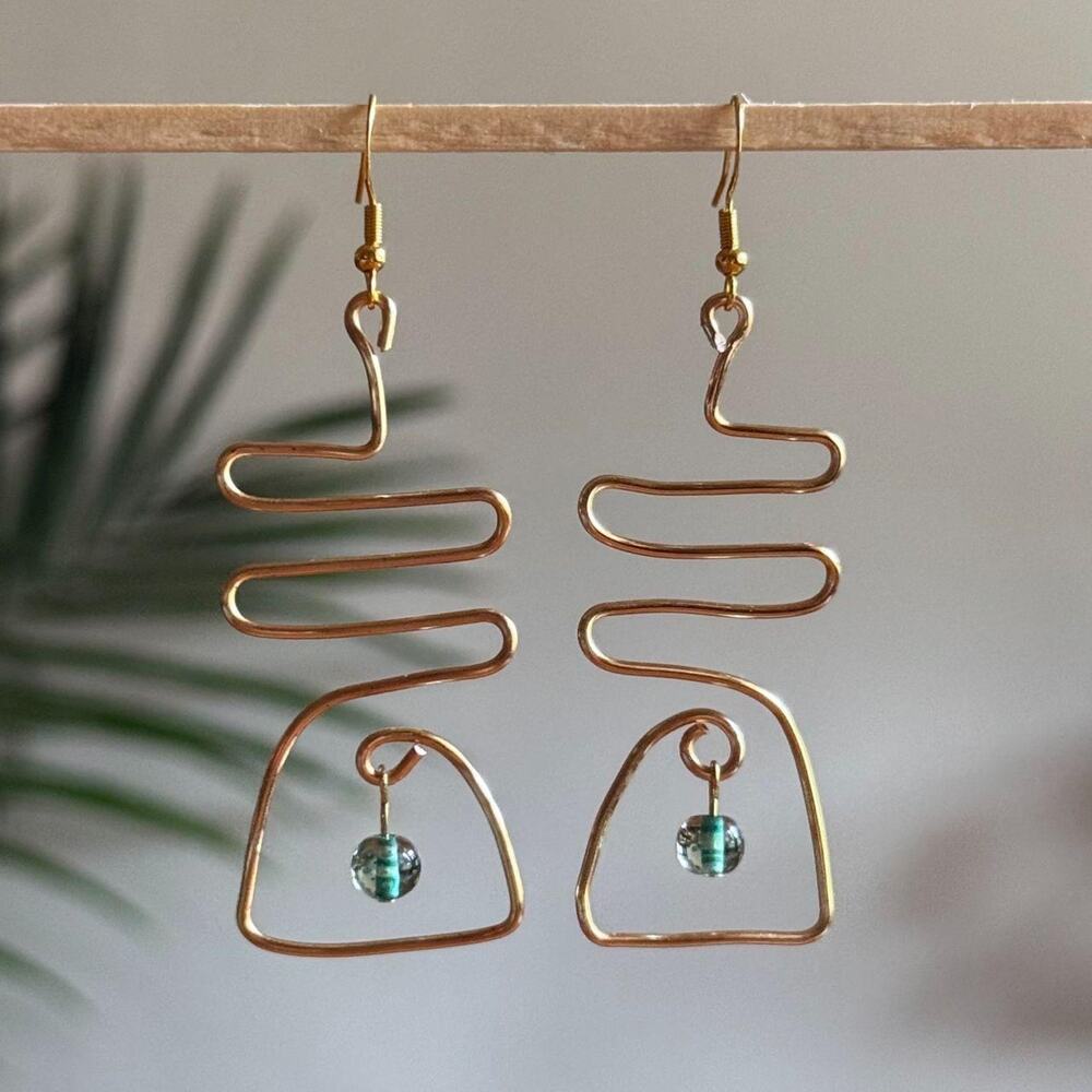 handmade gold wire wavy abstract earrings with dangling green round beads